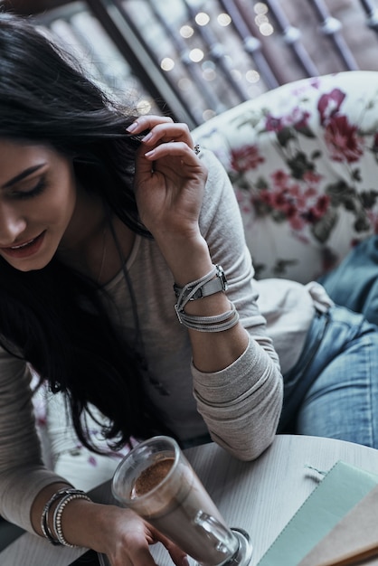 Pure beauty. Attractive young smiling woman touching her hair 