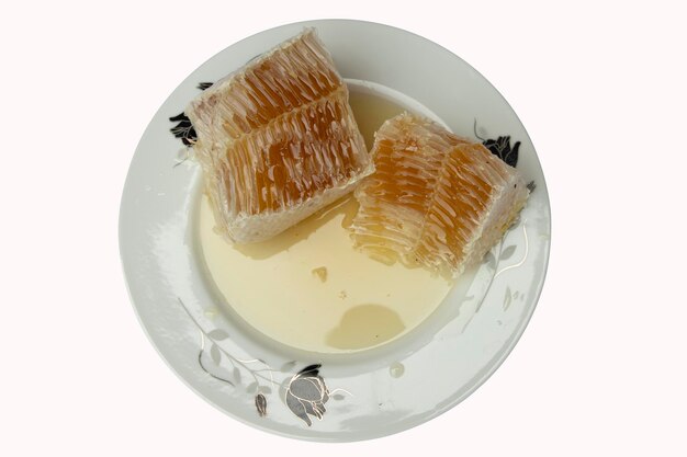 Pure honey in the plate on isolated white Background