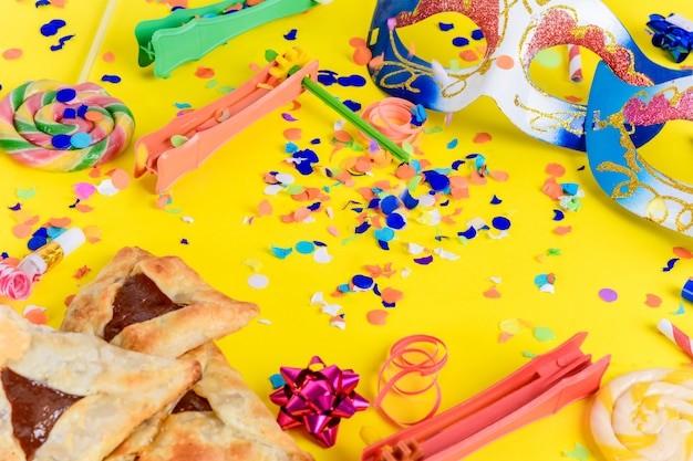 Purim with carnival mask, party costume and hamantasc