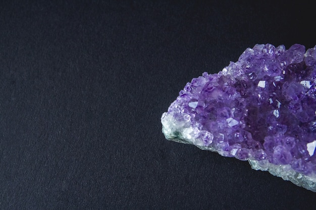 Purple amethyst crystal on a black background