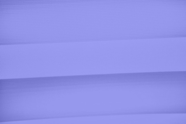 A purple background with a white curtain that is made of paper.