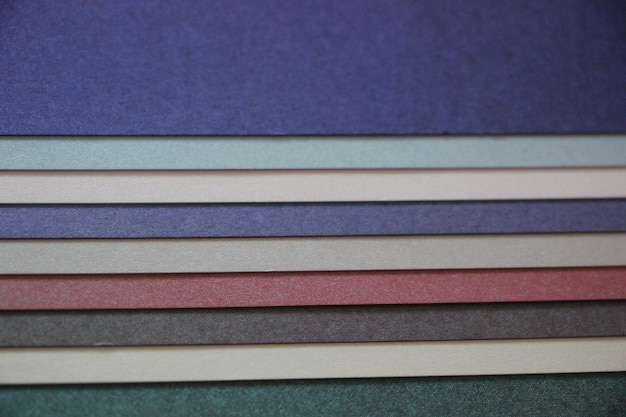 Purple blue grey teal mint background texture of colored paper on wooden table