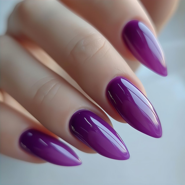 Purple colored nail polish on manicured nails