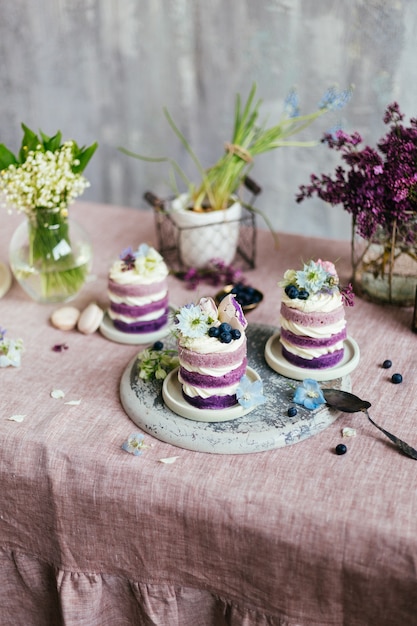 Purple cream cake decorated with spring flowers