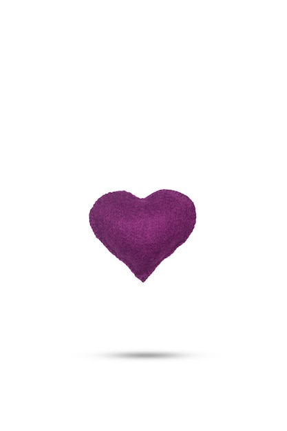 A purple fabric heart floating on a white background with copy space