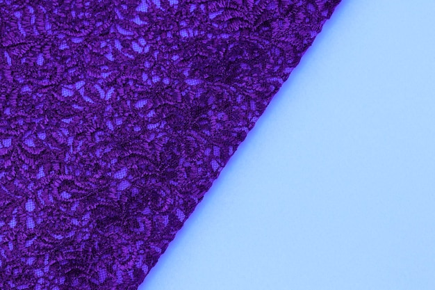 A purple fabric with a small flower pattern on it.