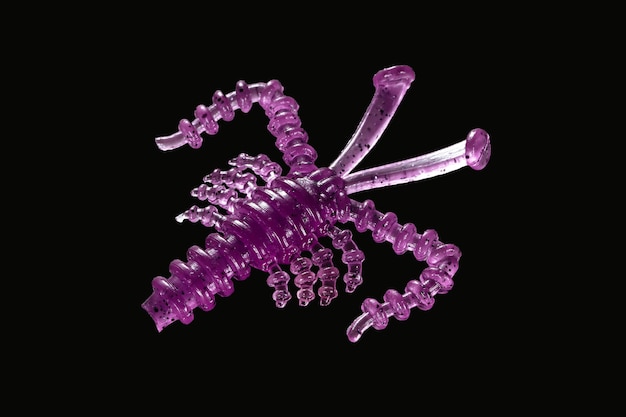 purple glass fish with purple beads on a black background