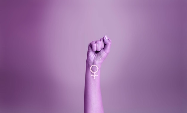 Photo purple hand of a woman for international womens day and the feminist movement