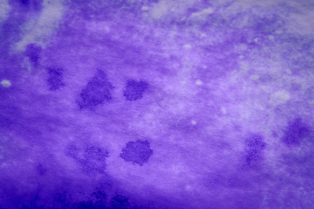 Purple ink stain on a sheet of white paper macro. Abstract background. Spreads ink stains with streaks on a white background. Absorb close-up