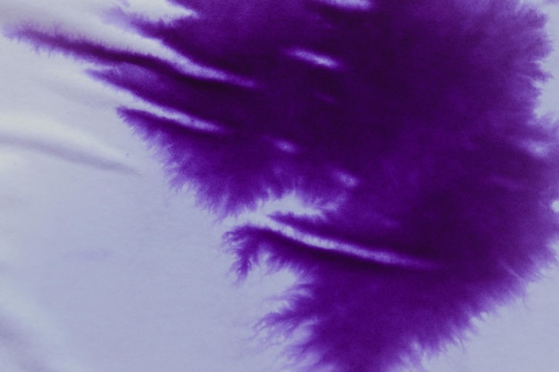 Purple ink stain on a sheet of white paper macro