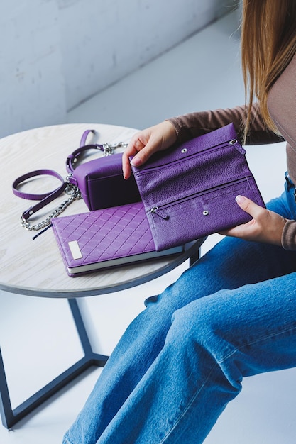 A purple leather bag in a girl's hand Woman with luxury bag