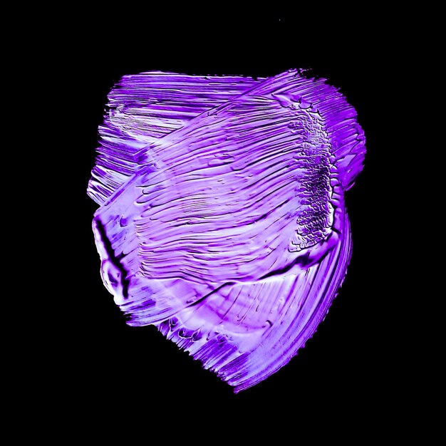 Purple neon paint brush stroke texture isolated on black background