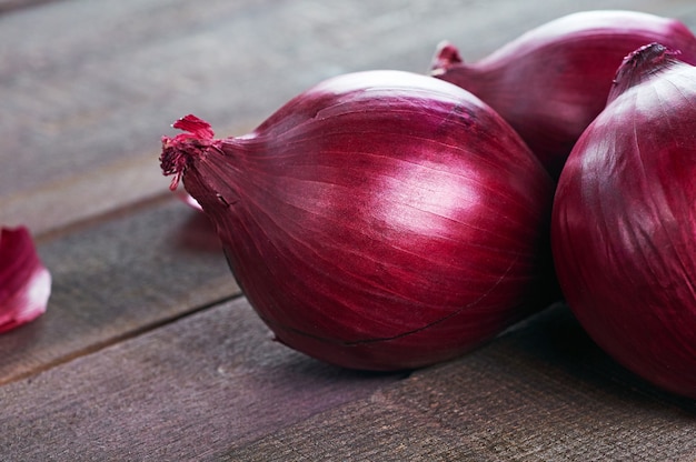 Purple onion on a wooden background