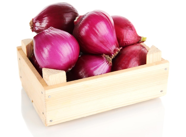 Purple onion in wooden box isolated on white