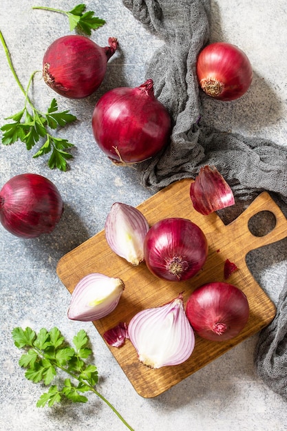 Purple Onions Fresh whole purple onions and one sliced onion Top view flat lay background