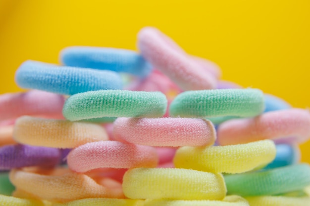 Purple pink and violet rotating close up many rubber bands defocused group colored circular textile