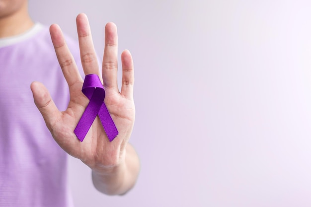 Purple Ribbon for Violence Pancreatic Esophageal Testicular cancer Alzheimer epilepsy lupus Sarcoidosis and Fibromyalgia Awareness month and World cancer day concept