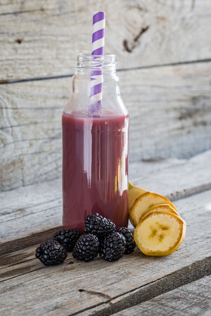 Purple smoothie on rustic wood  