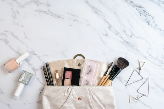 Purse of cosmetics and women accessories on marble background,Copy space ,top view.