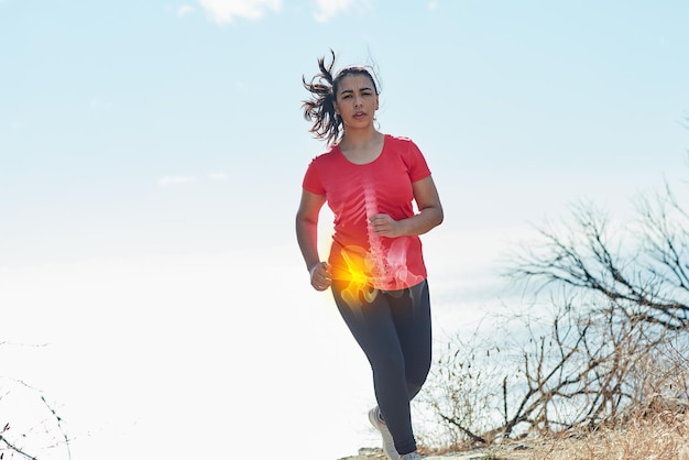 Pushing through the pain Shot of an attractive young woman running outdoors with her hip injury highlighted