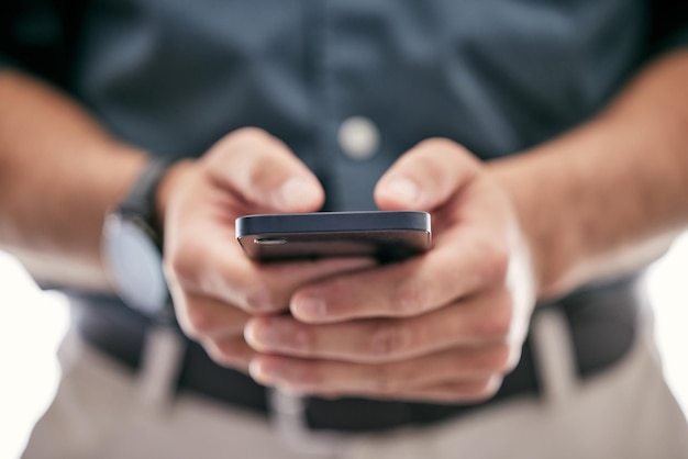 Putting the pieces together Shot of an unrecognizable businessman using a smartphone in a modern office