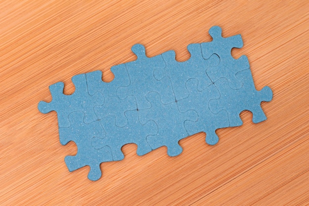 Puzzle pieces on wooden table