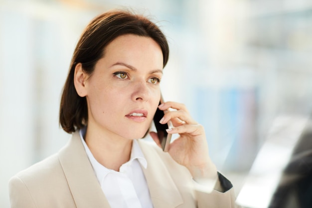 Puzzled lady talking by phone