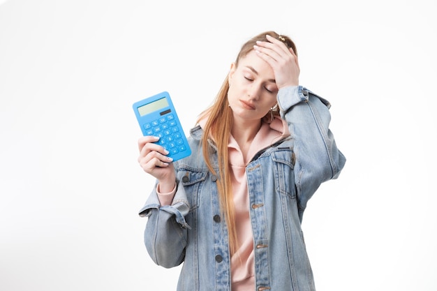 Puzzled woman student with calculator isolated on white background