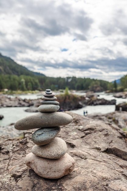 A pyramid of bare stones stacked on top of each other. Stones stacked in the shape of a pyramid