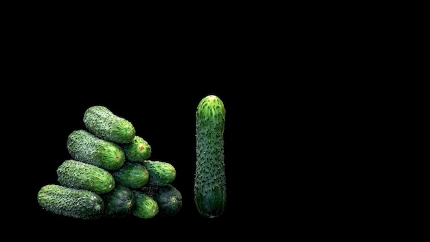 Pyramid of cucumbers on a black background