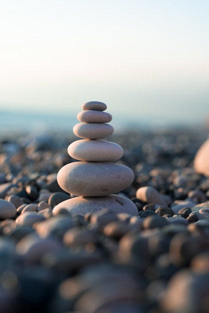 Pyramid of pebbles on the beach sea