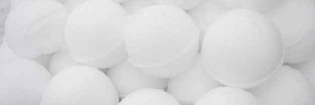 Pyramid or a pile of perfect snowballs on frosty winter day in forest or garden outdoor snowy winter season and fun entertainment in nature banner