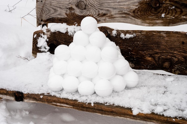 Pyramid or a pile of perfect snowballs on frosty winter day in forest or garden outdoor snowy winter season and fun entertainment in nature