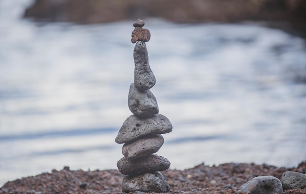 Pyramid of sea pebbles on beach Life balance and harmony concept Balancing nature