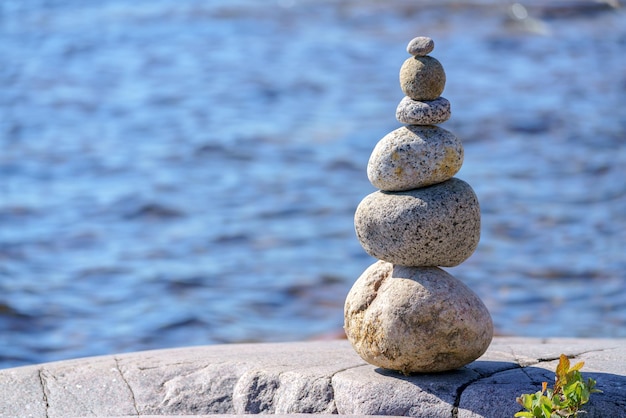 Pyramid of stones Unstable balance of stone objects Idyllic state of nature