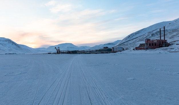 Pyramiden, Svalbard. Snowmobile tracks on the sea ice, leading to Pyramiden harbour.