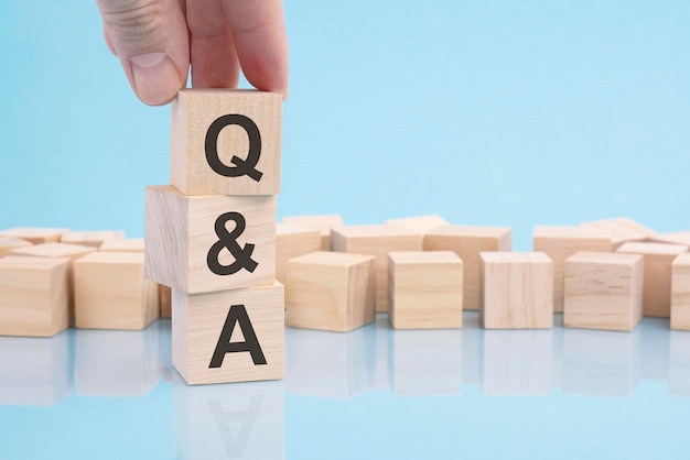 Q and A an abbreviation of wooden blocks with letters on a blue background selective focus