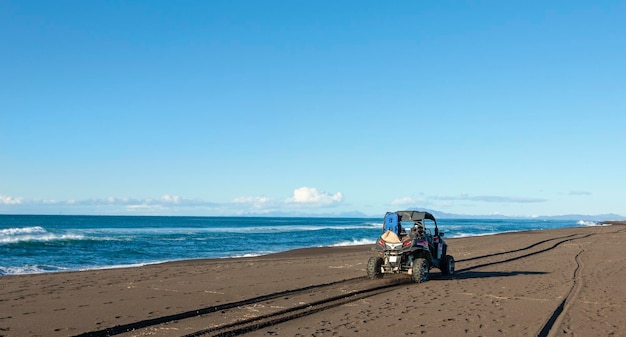 Quad bike on the sand by the Pacific ocean