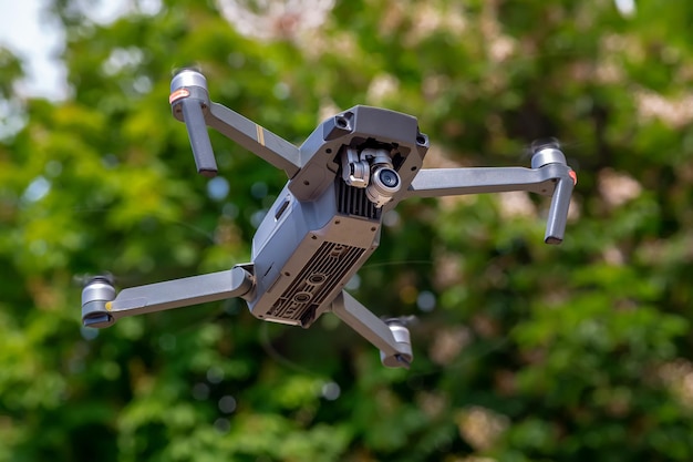 Quadcopter in flight against a blue sky