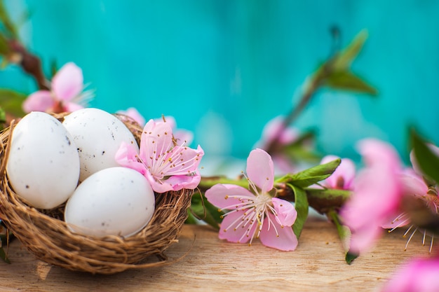 Quail eggs in a diy nest. Easter card in trendy color.