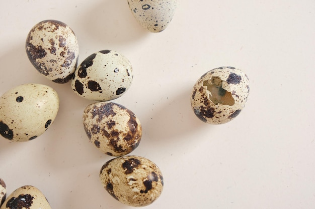 Photo quail eggs on light texture background copy space