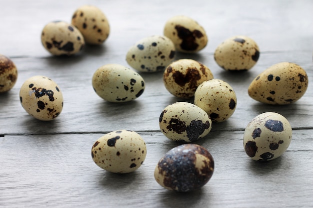 Quail eggs on a light wooden boards. Easter holiday background.