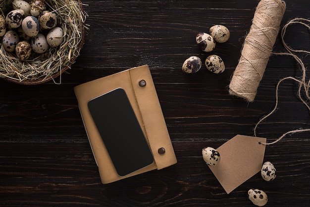 Quail eggs in a nest place for text on wooden rustic background top view close up