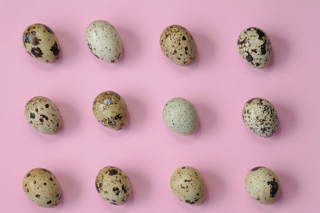 Quail eggs set on a light pink table