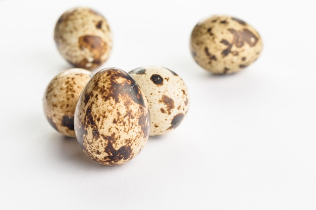 Quail eggs on white background. Organic product.