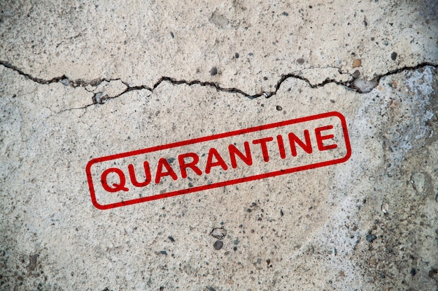 Quarantine on a concrete wall with a crack