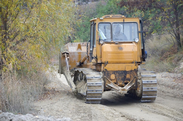 Quarry aggregate with heavy duty machinery Caterpillar loader Excavator with backhoe driving to construction site quarry