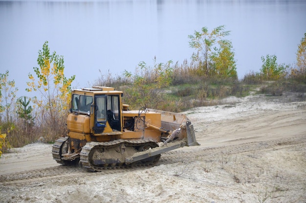 Quarry aggregate with heavy duty machinery Caterpillar loader Excavator with backhoe driving to construction site quarry