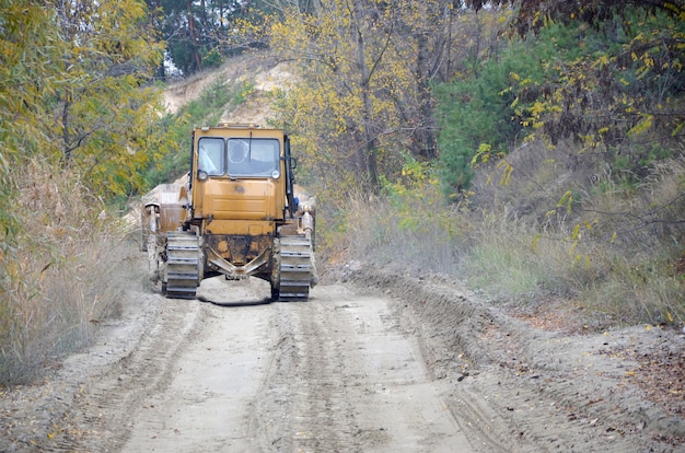 Quarry aggregate with heavy duty machinery. Caterpillar loader Excavator with backhoe driving to construction site quarry