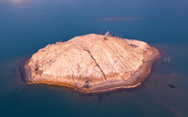 Quarry for mining and enrichment of titanium and other rare ores. Blue water in the enrichment tank.